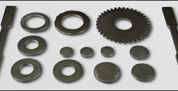 Assorted 3D printed metal parts including washers, gears, and flat bars arranged on a white background.