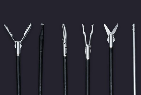 Five different types of medical forceps arranged vertically against a dark grey background.