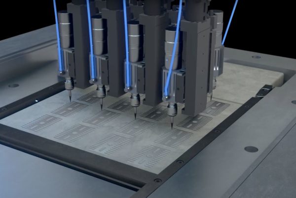 Multiple industrial robotic arms simultaneously engraving detailed patterns on a metal sheet.