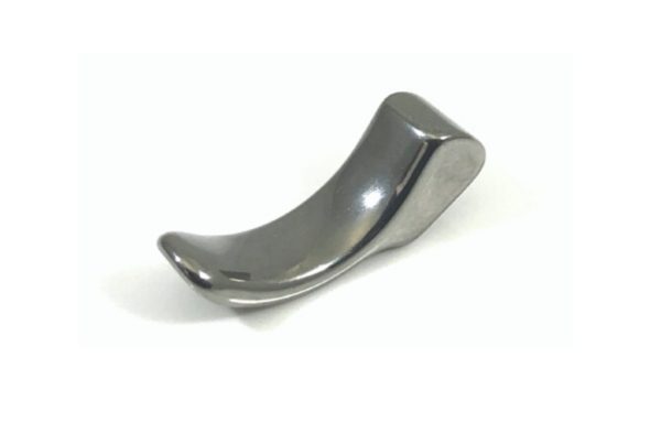 A shiny, curved, metallic object with a smooth surface, resembling a small ergonomic tool, placed on a plain white background.