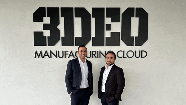 Two men in business attire stand in front of a wall with a large "3DEO" logo and the words "MANUFACTURING CLOUD" beneath it, highlighting their expertise in 3D printing metal.