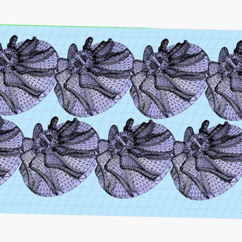 3D rendering of eight identical mesh apple models, optimized through design for additive manufacturing, arranged in a grid pattern on a light blue grid background.